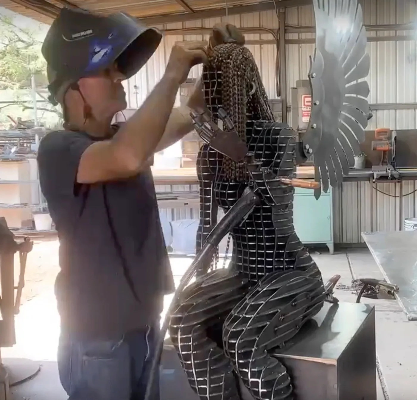 John fitting the steel layers of a winged figure by hand in his studio